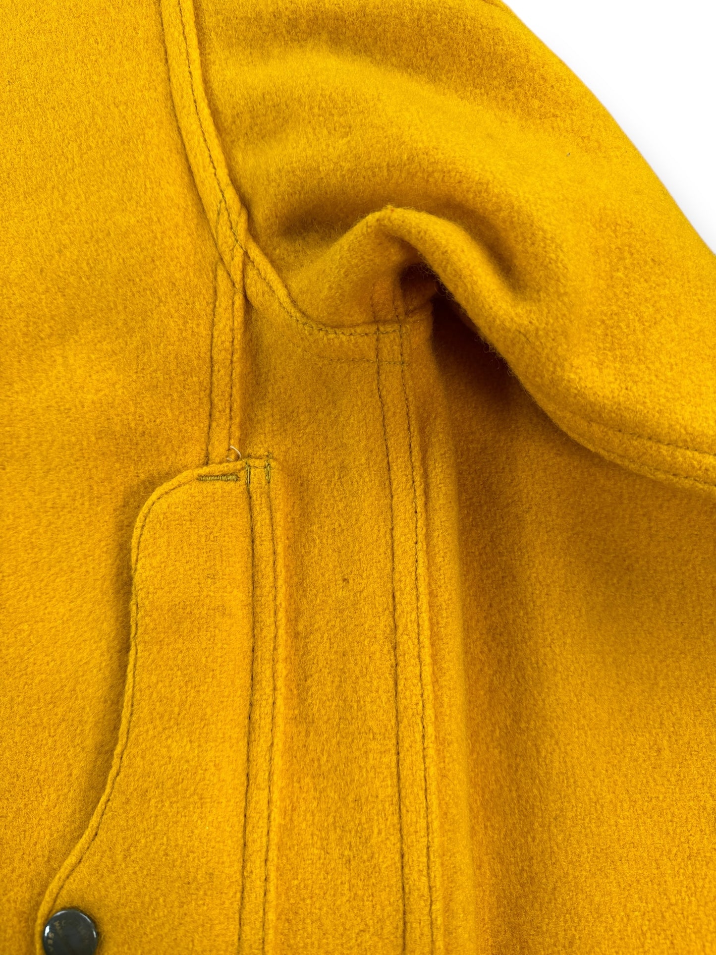 Small Moth Nibble Near Map Pocket on Rear of Filson Gold Cruiser 