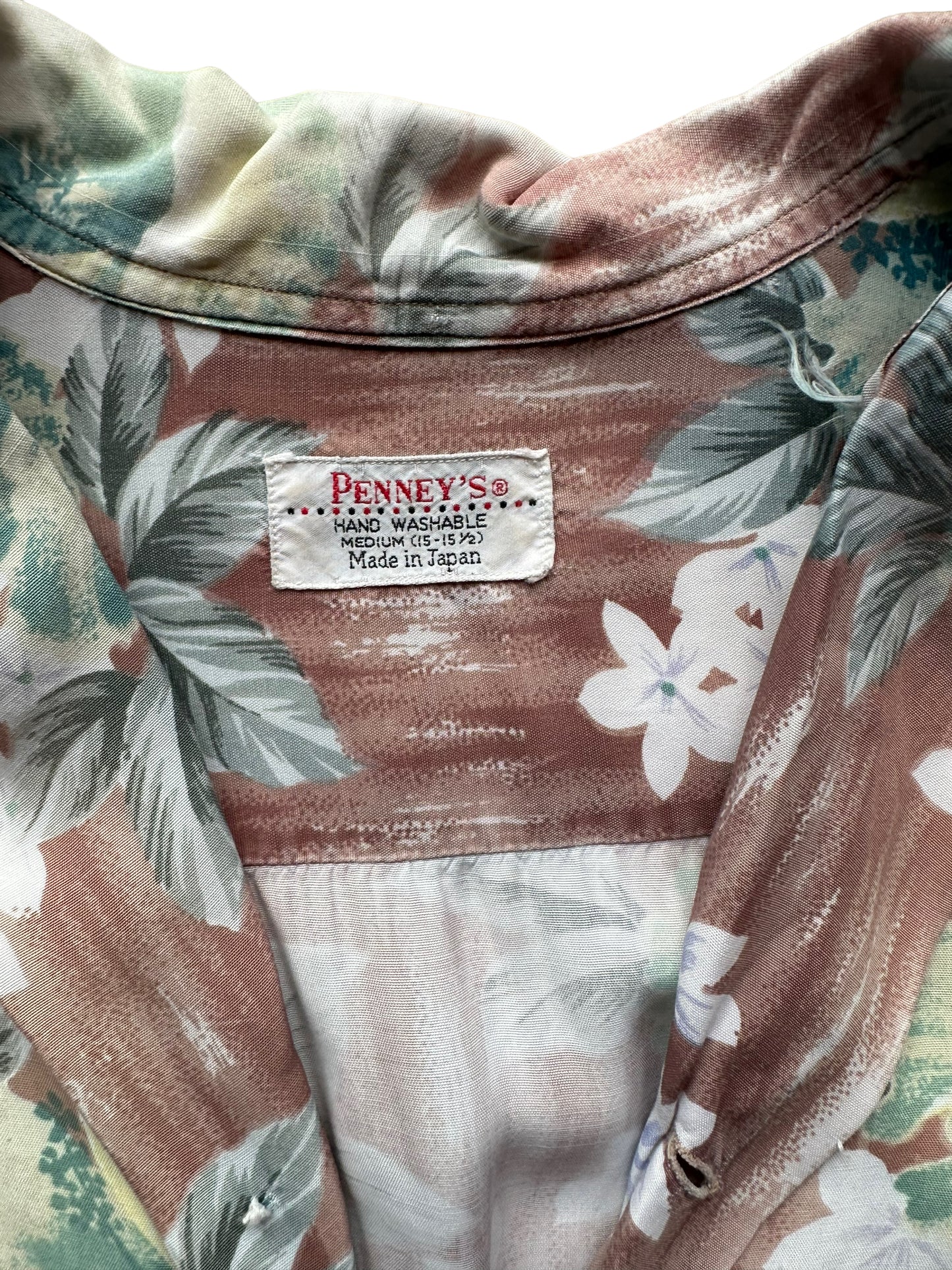 Tag shot of Vintage Made in Japan Penney's Brown/Green Floral Aloha Shirt SZ M | Seattle Vintage Rayon Hawaiian Shirt | Barn Owl Vintage Clothing Seattle