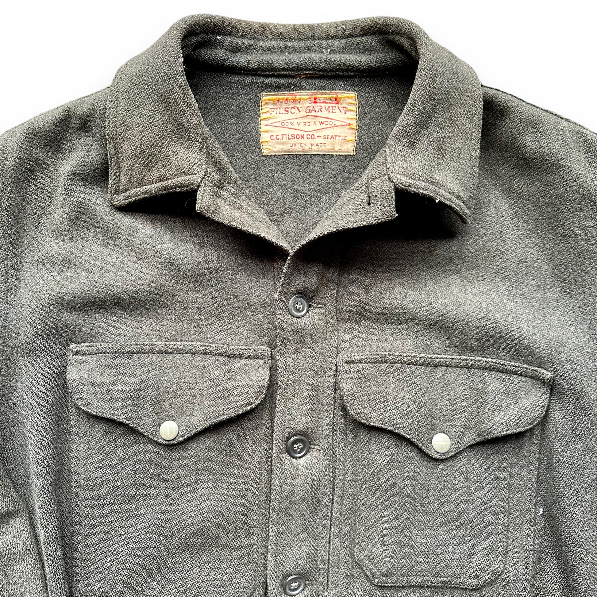 Upper Front View with Tag on Vintage Union Made Era Visibly Repaired Filson Forestry Cloth Cruiser SZ 44 |  Barn Owl Vintage Goods Seattle | Vintage Workwear Seattle