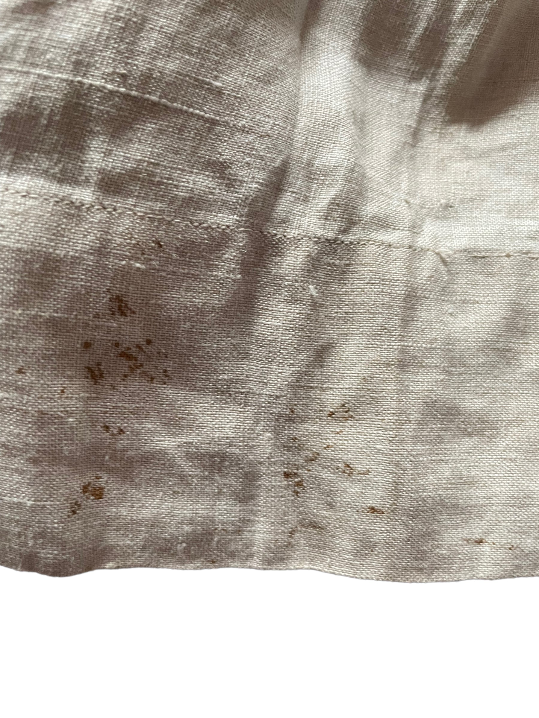 Stains along hem Antique Early 1900s Linen Dress SZ XSClose up of stains along hem Antique Early 1900s Linen Dress SZ XS
